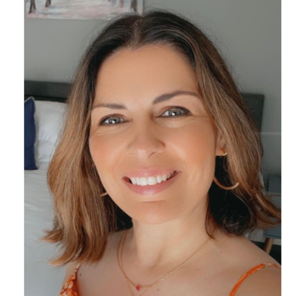 Michelle Shirley A wpman with light brown hair to her shoulders facing the camera smiling